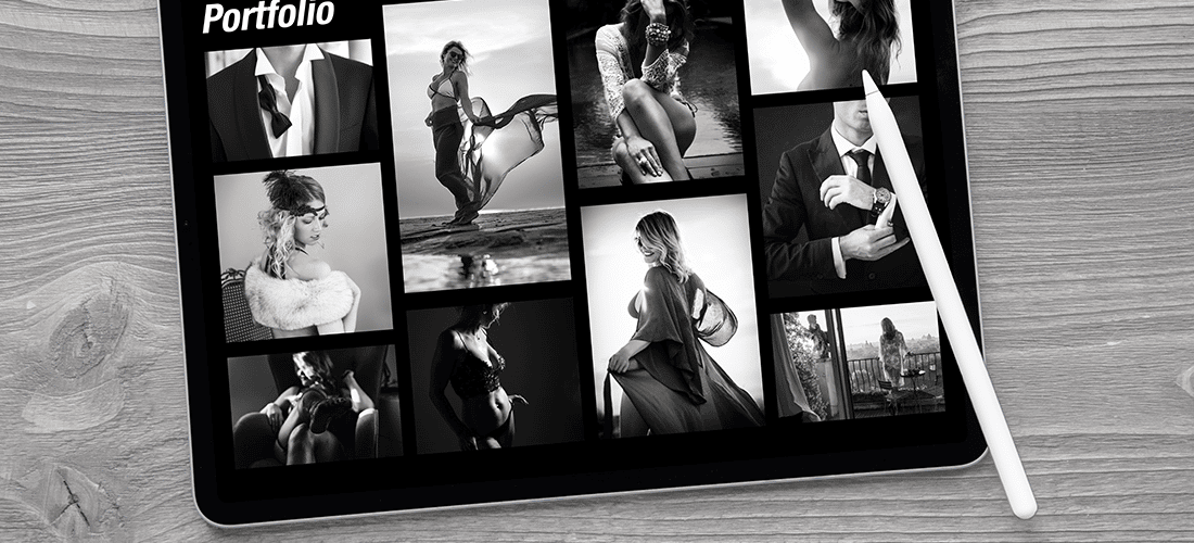 black and white overhead shot of a portfolio website open on a tablet which sits on a wooden surface