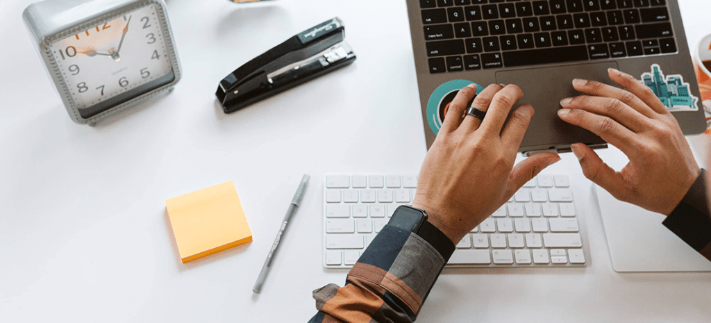 a man works on a laptop on an elevated laptop stand