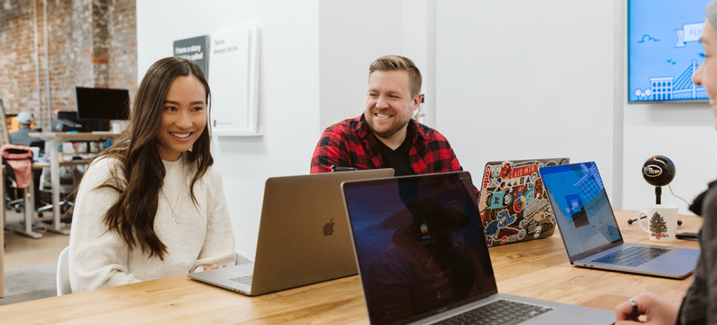 coworkers share a laugh while working on a project