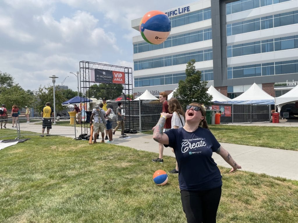 A WP Engine employee bats around a beach ball at Maha Music Festival