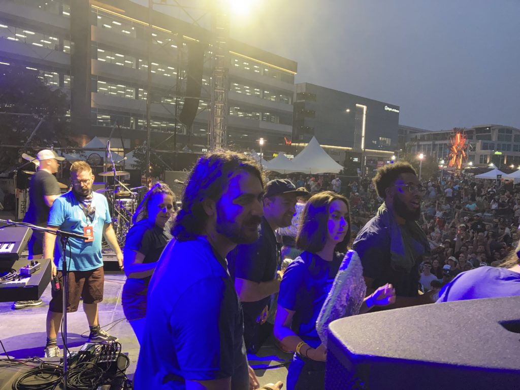 WP Engine employees on stage at night during Maha Music Festival