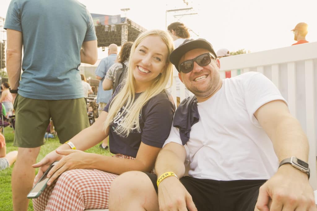 A man and a woman smile while attending daytime events at Maha Music Festival