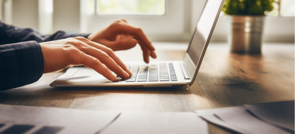 person typing on laptop working on website