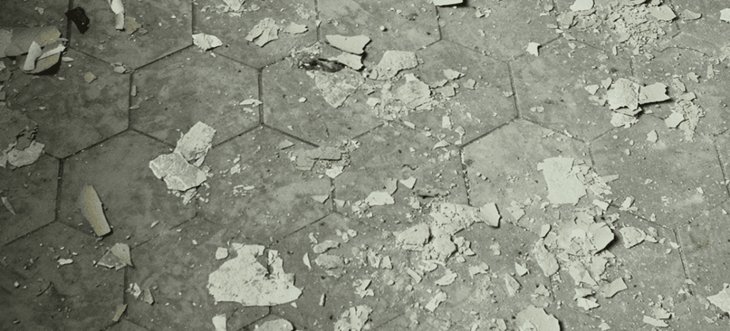 paint chips strewn across a floor comprised of hexagonal stones