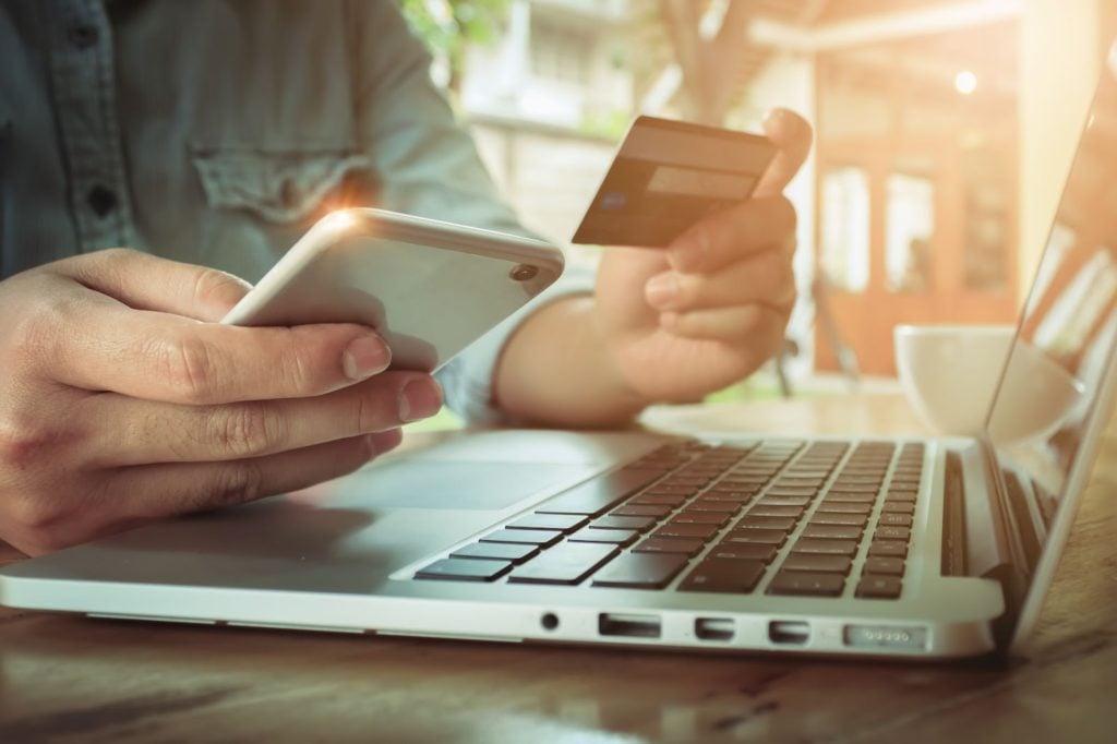 a person enters their credit card information via mobile while shopping online