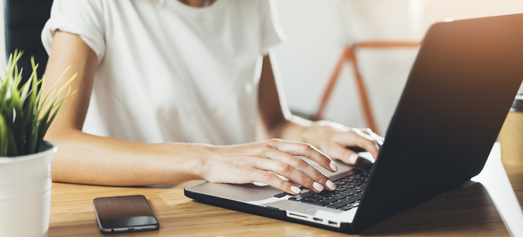 a woman opens the WordPress dashboard on a laptop